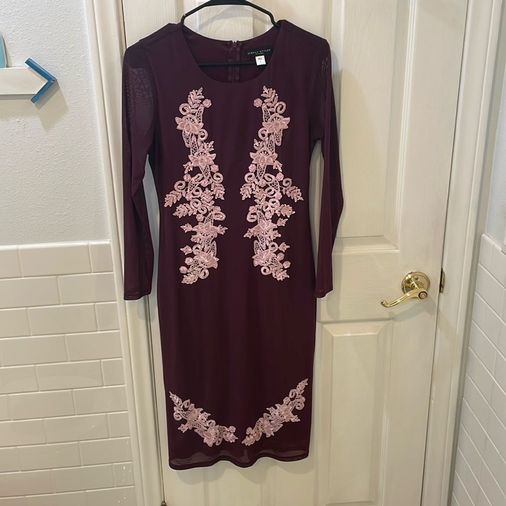 Short, purple cocktail dress with sleeves.